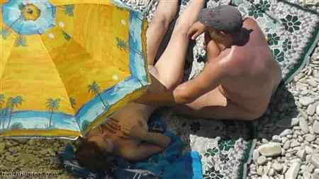 Dude secretly strokes a beautiful chick on the beach