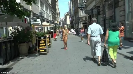 Naked blonde walks along busy streets