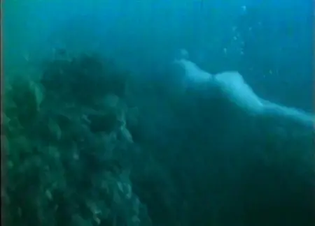 Naked beauty swims under water at a great depth