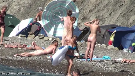 Naked people are taken secretly on the beach