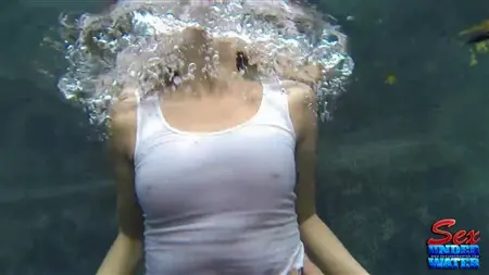 A thin chick swims under water and jerks off