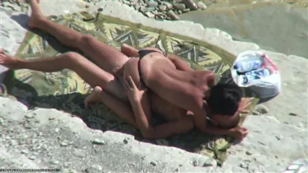 On the nudist beach, the girl fingering the guy