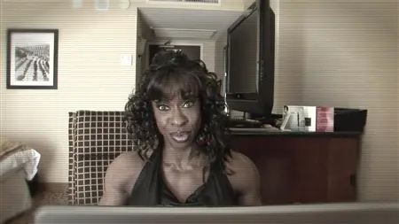 A black woman at a hotel boasts her muscles