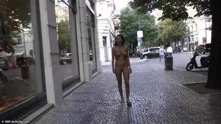 Walk of a naked brunette in the city center