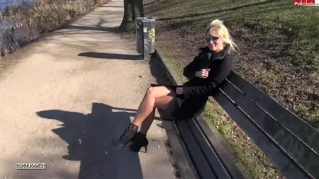 A pretty girl walks naked along the street and fucks on a bench