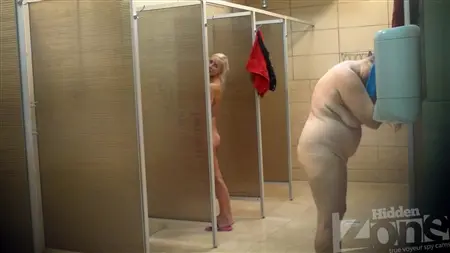 A slender blonde is washed in a public soul with fat women