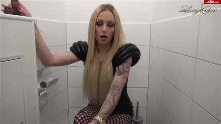 Tattooed blonde exercises with a rubber member in the toilet